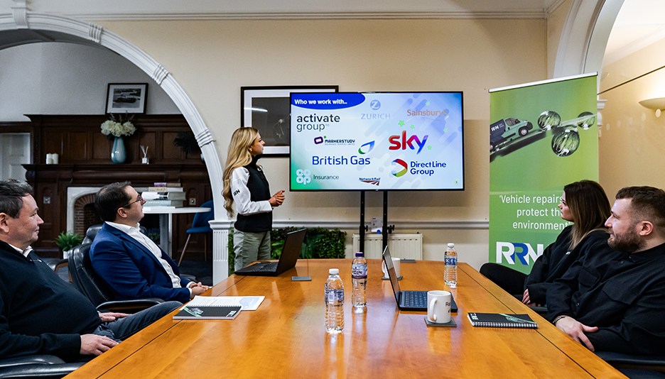 About RRN Team members in meeting room looking at tv screen presentation